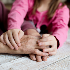 Hands of children and elderly